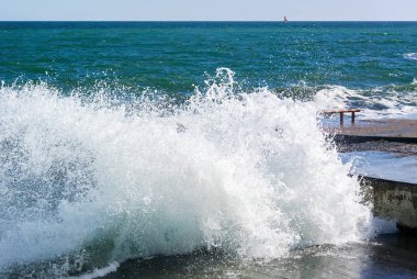 Fotoğraf üzerinde çok sayıda su sıçramalarına demirleme beton kırma deniz dalga