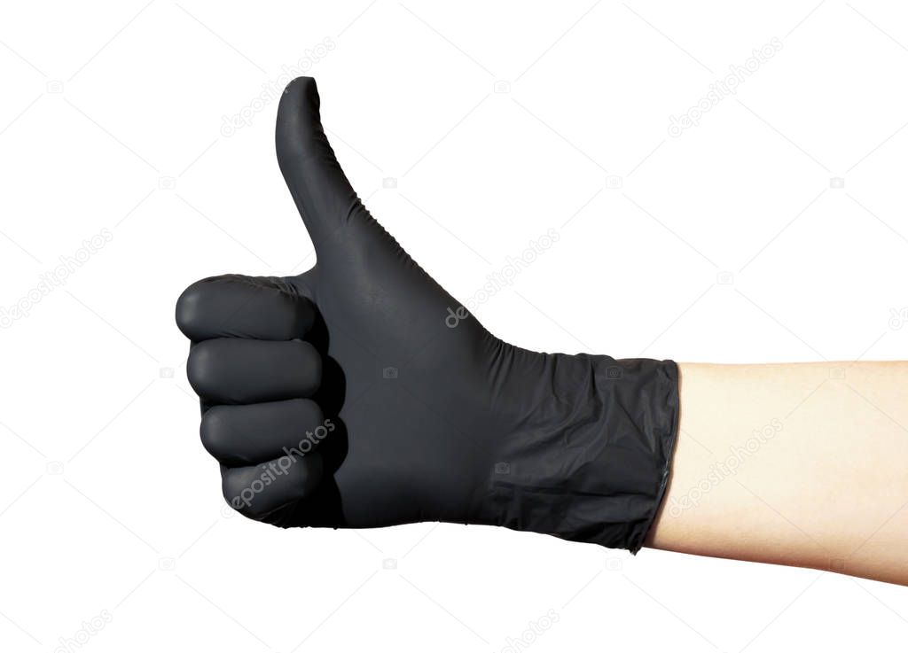  Female hand in black glove shows ok sign on a white background. Thumb raised up