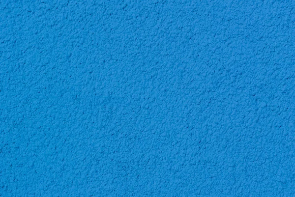 Mavi boyalı alçı kaba bir doku ile bir duvar fotoğrafı
