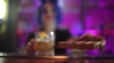kadın barmen. mavi saçlı kız. gece barda kokteyl yapımı