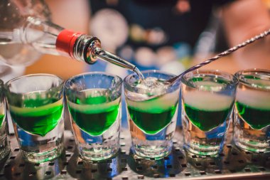 Fondip bardakları tezgahta duran yeşil sıvı. barmen görüntüleri hazırlama