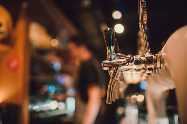 The system of bottling beer on the table of customers in the brewery.