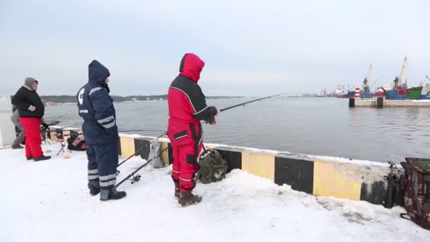 Ventspils, Letland. -10 December 2017: mensen permanent op mol en op zoek naar bevroren poort — Stockvideo