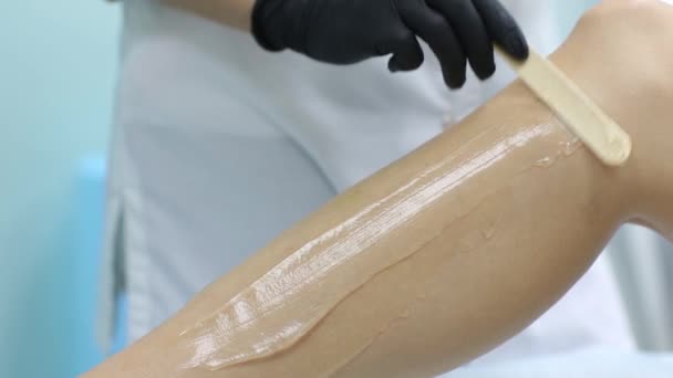 Beauty, depilation, epilation, hair removal and people concept - beautiful woman with applicator applying depilatory wax to her leg. — Stock Video