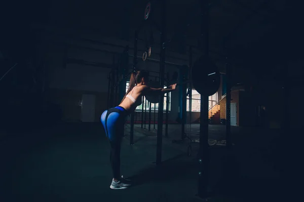 Jonge Sportvrouw voorbereiden om barbell in sporthal. — Stockfoto