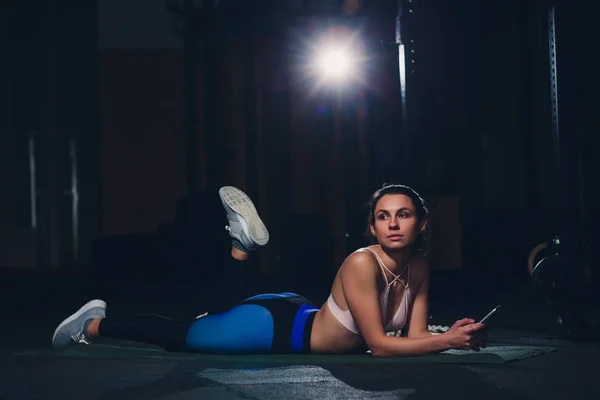 Fit jonge vrouw liggend op oefening mat doen oefeningen van de maag. — Stockfoto