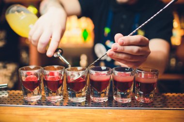Barmen tekila çubuğunun arka planı cam içine yağıyor.