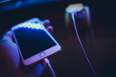 Eller kadının smartphone cep telefonu cihaz kablo ve adaptör ile şarj.