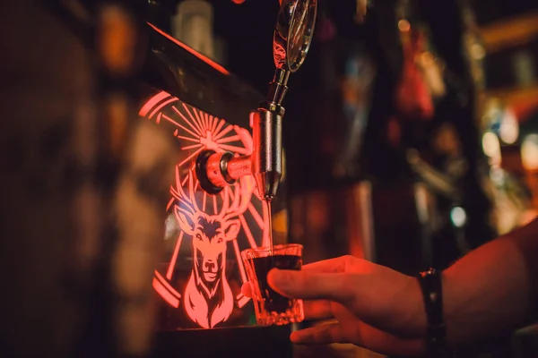 Ufa, Russia, HARATS PUB, 15 November, 2018: Jagermeister alcohol drinks in bar. bartender pours a glass. — Stock Photo, Image