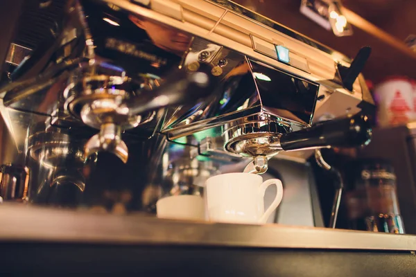 Professional coffee machine making espresso in a cafe.