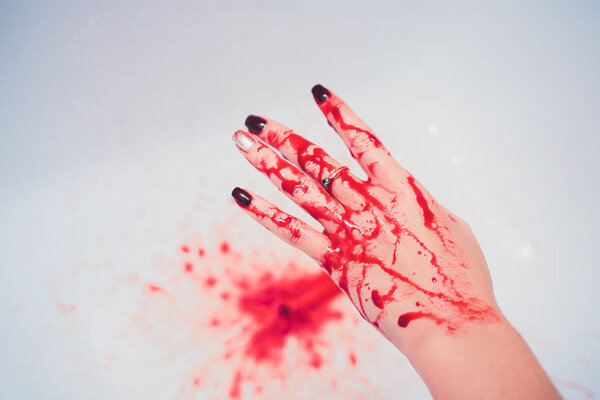Hand in blood on a white background.