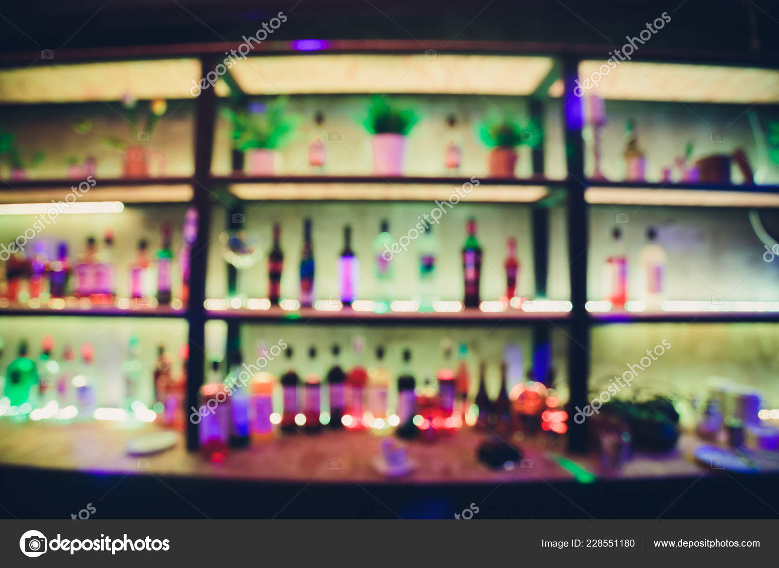Blur alcohol drink bottle at club pub or bar in dark party night background.  Stock Photo by © 228551180