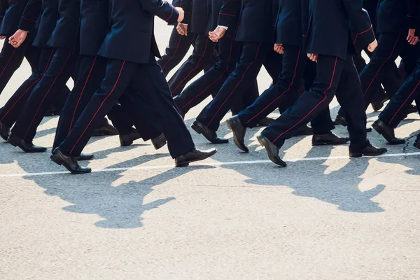 the police are marching. legs. shoes in line