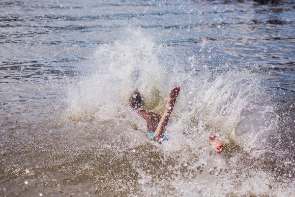 Jonge man springen in het water — Stockfoto