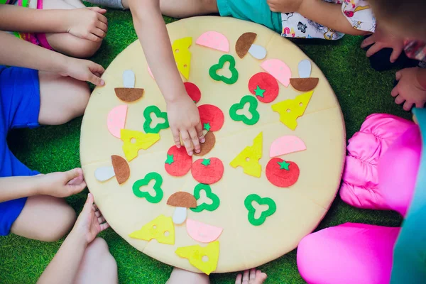 Los niños están jugando. pizza de almohada. La sujeción de las manos con ingredientes de velcro para pizza —  Fotos de Stock