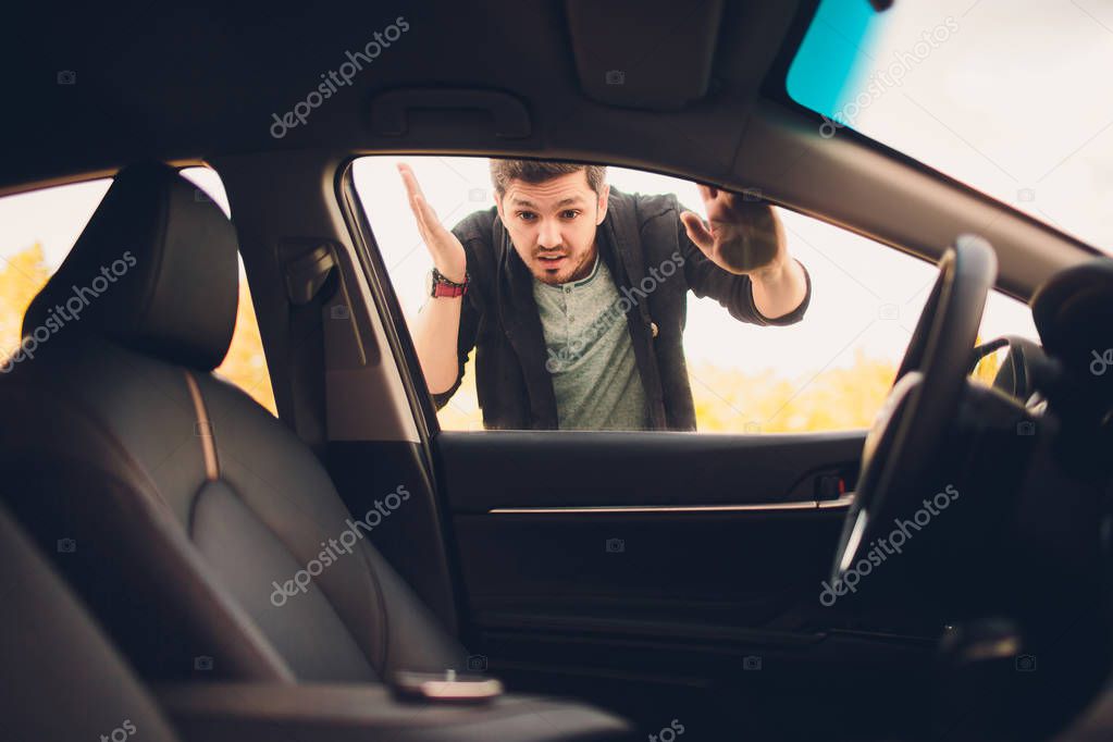 man forgot the key inside of his car.Transportation, crime and ownership concept