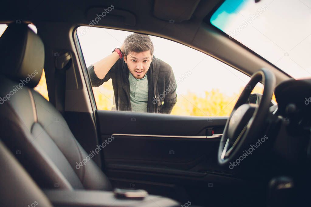 man forgot the key inside of his car.Transportation, crime and ownership concept