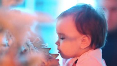 Küçük yürümeye başlayan çocuk kız Noel ağacının yanında ayakta. Neşeli Noel ve mutlu tatiller.