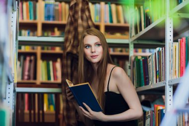 Güzel kız öğrencinin Üniversite Kitaplığı'nda