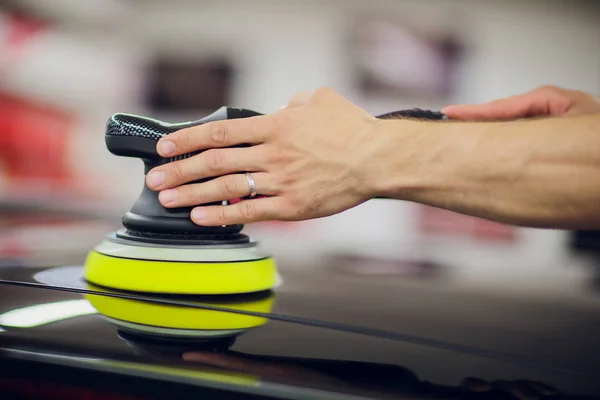 Polished black car polishing machine polished finishing. Car detailing. Selective focus.