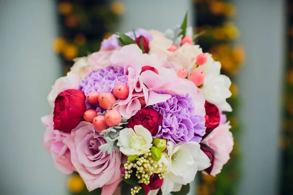 Mixed flower arrangement: wedding flowers in pink and purple blue.
