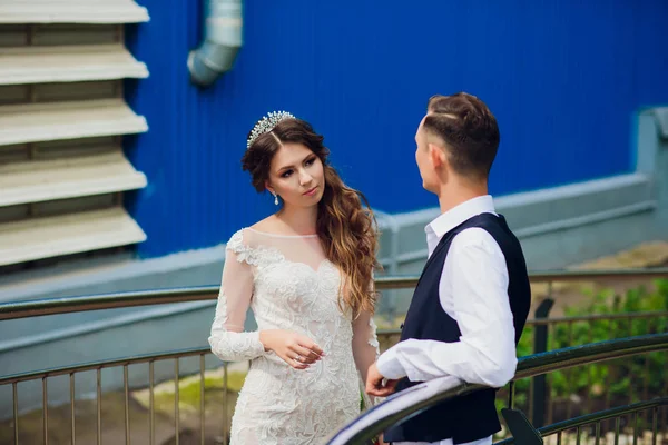 Noiva e noivo andando na cidade, dia do casamento, conceito de casamento. Noiva e noivo em fundo urbano. jovem casal indo em uma escada no dia do casamento . — Fotografia de Stock