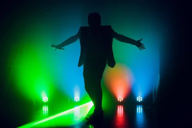 Şovmen. Mikrofon tutan genç zarif konuşan adam