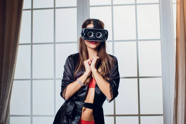 Vr ゴーグルを使用してベッドでランジェリーを身に着けている美しい女性. — ストック写真