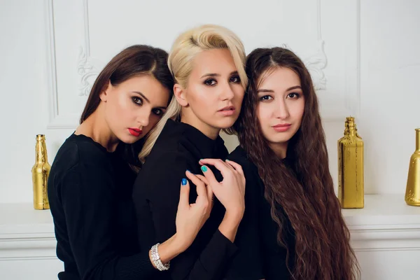Tre lekfulla attraktiva unga kvinnor vit bakgrund. — Stockfoto