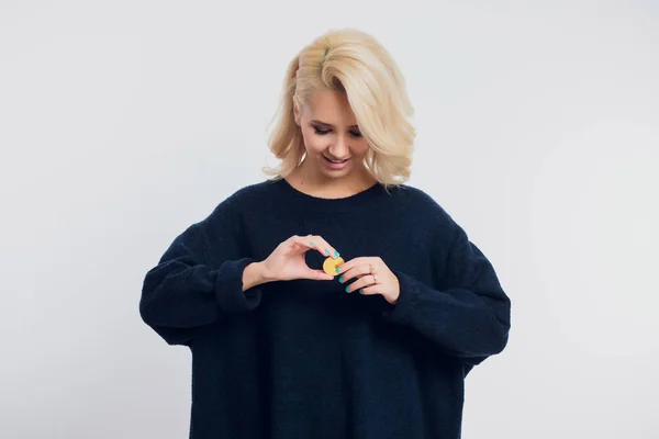 Retrato de una joven mujer de negocios rubia con una camisa negra, bitcoin . — Foto de Stock