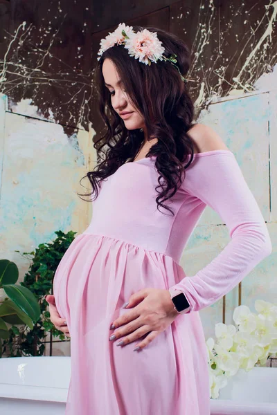 Pregnancy woman in pink lace dress