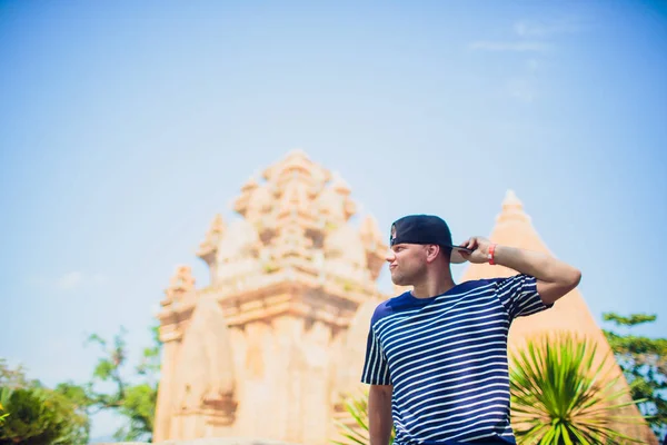 Caucasian man cap Vietnam wat temple on background