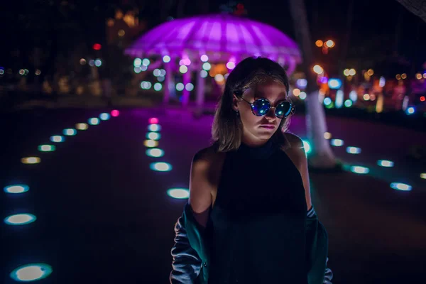 Beautiful girl on a background of night illumination in asia — Stock Photo, Image