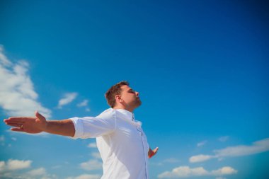 Yakışıklı adam beyaz kıyafetlerle deniz sahne poz