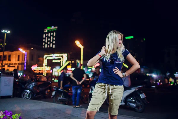 Beautiful girl on a background of night illumination in asia — Stock Photo, Image