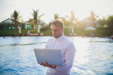 Tatil Yüzme Havuzu yanında çalışan genç serbest meslek