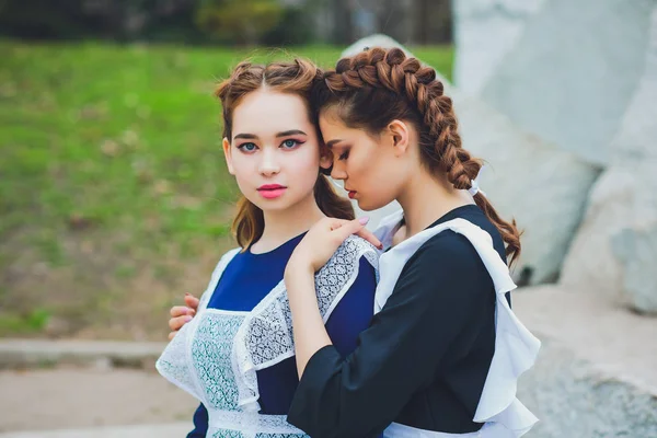 Stojící školačka s typickou tmavě bílou zástěru jednotné — Stock fotografie