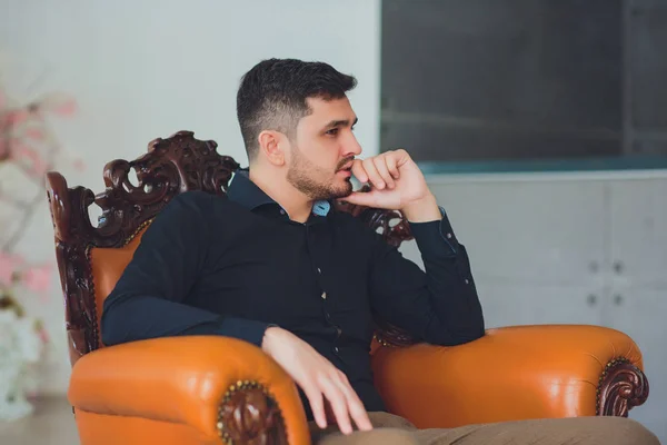 Handsome young man home sitting on couch — Stock Photo, Image