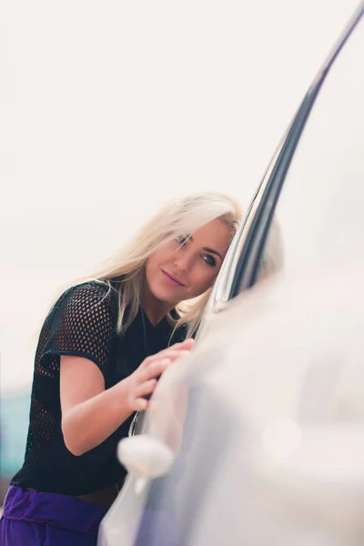그녀의 새로운 차를 포옹 쾌활 한 젊은 여성 드라이버. — 스톡 사진