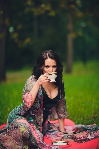 Усміхнена дівчина з кухоль в руках. Дівчина п'є чай . — стокове фото