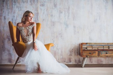 kız elbise, kitaplık, modern iç kız yanında sandalyede oturur