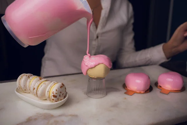 watering glaze cake, confectioner makes sweets, cake similar heart shape