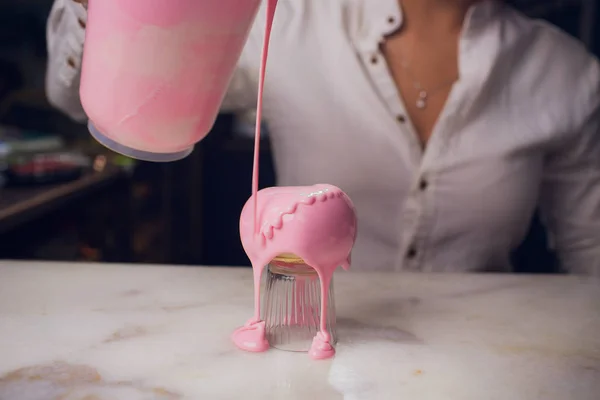 watering glaze cake, confectioner makes sweets, cake similar heart shape