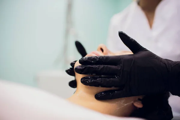 Mit sterilem Serviettengesicht abwischen. junge Frau lässt sich in Schönheitssalons behandeln. — Stockfoto