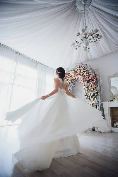 stock image Beautiful bride in a gentle dress lace dress with a long train.