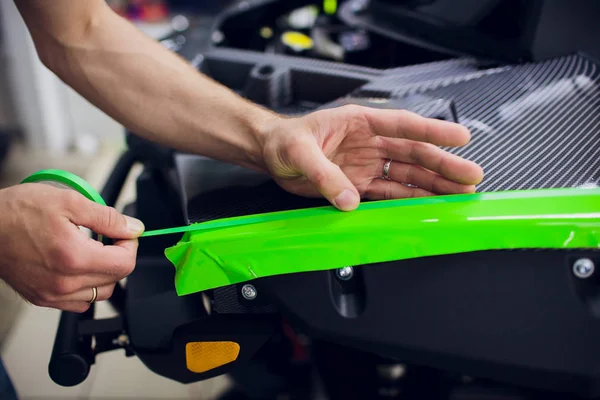 Car ATV wrapping specialists wrapping vehicle with green vinyl film or foil