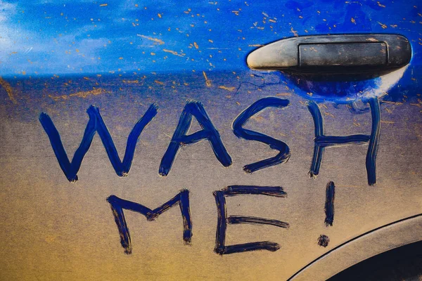 Wash Me Words on Dirty Car Stock Picture