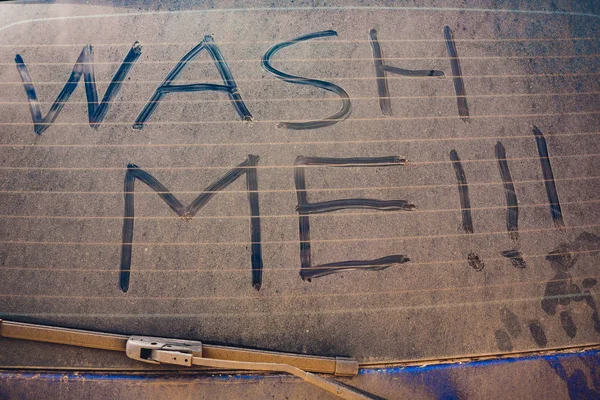 Wash Me Words on Dirty Car Stock Picture