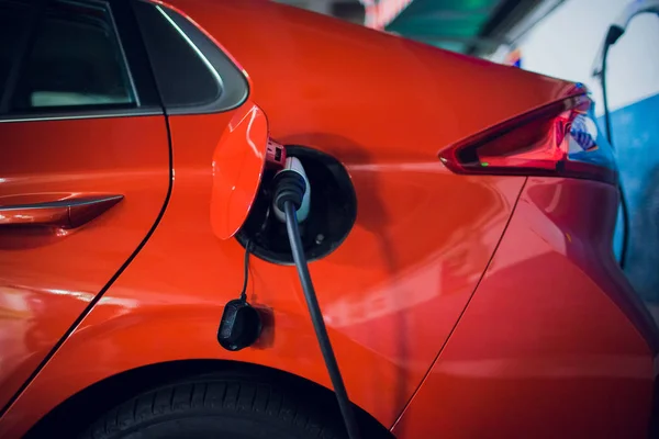 Power supply connect to electric vehicle for charge to the battery. Charging technology industry transport which are the futuristic of the Automobile. EV fuel Plug in hybrid car.