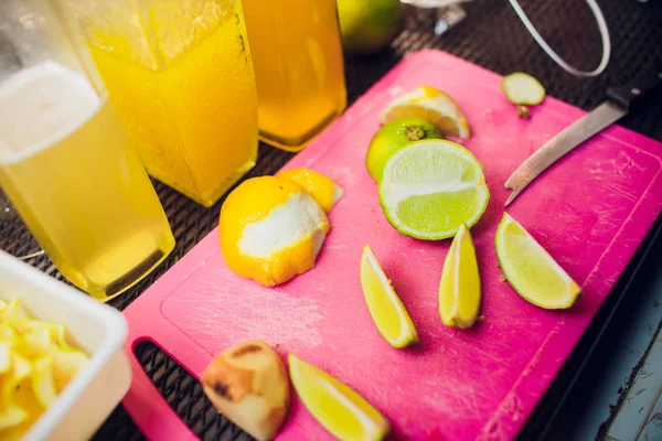 Close-up image des barmans mains coupant du citron vert cru, mûr et frais Préparation exotique de boissons fruitées composition . — Photo